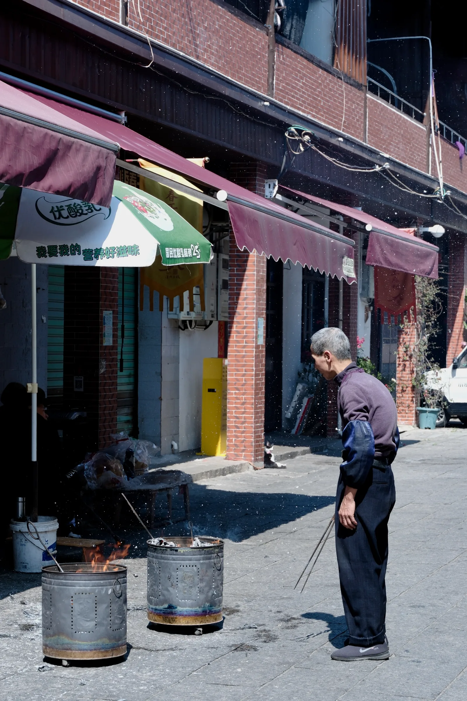 Man with fire barrels