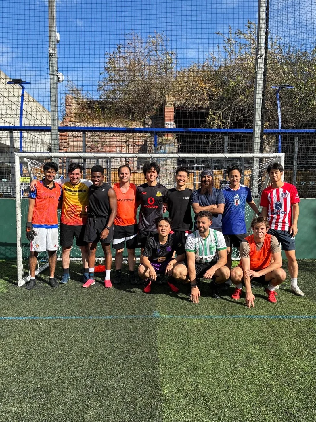 Wilson with his football team on an outdoor pitch
