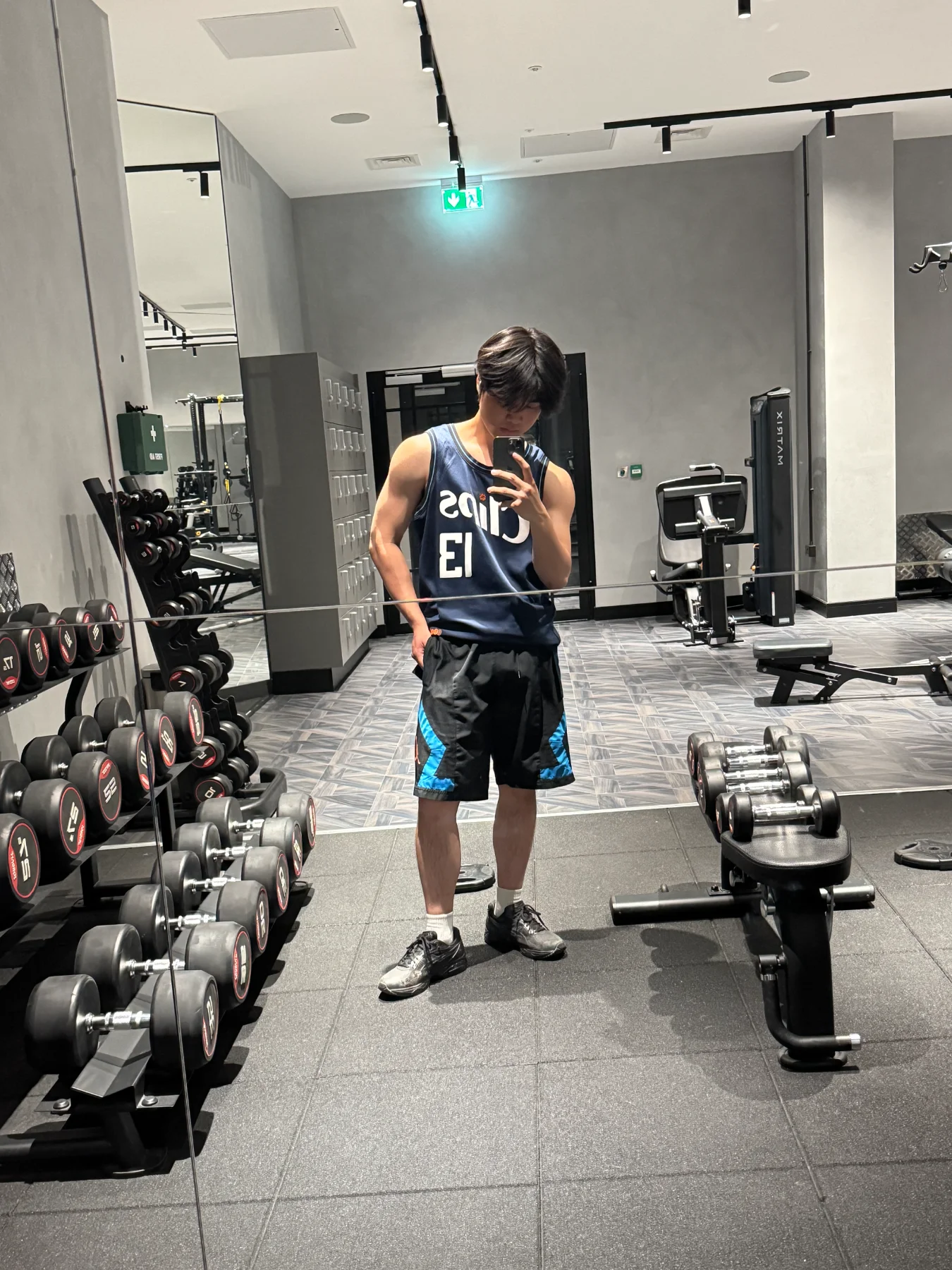 Wilson taking a mirror selfie in the gym
