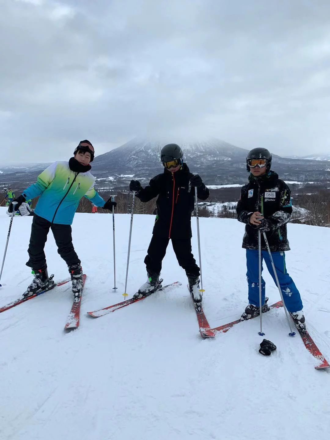 Wilson skiing with two friends on a snowy slope