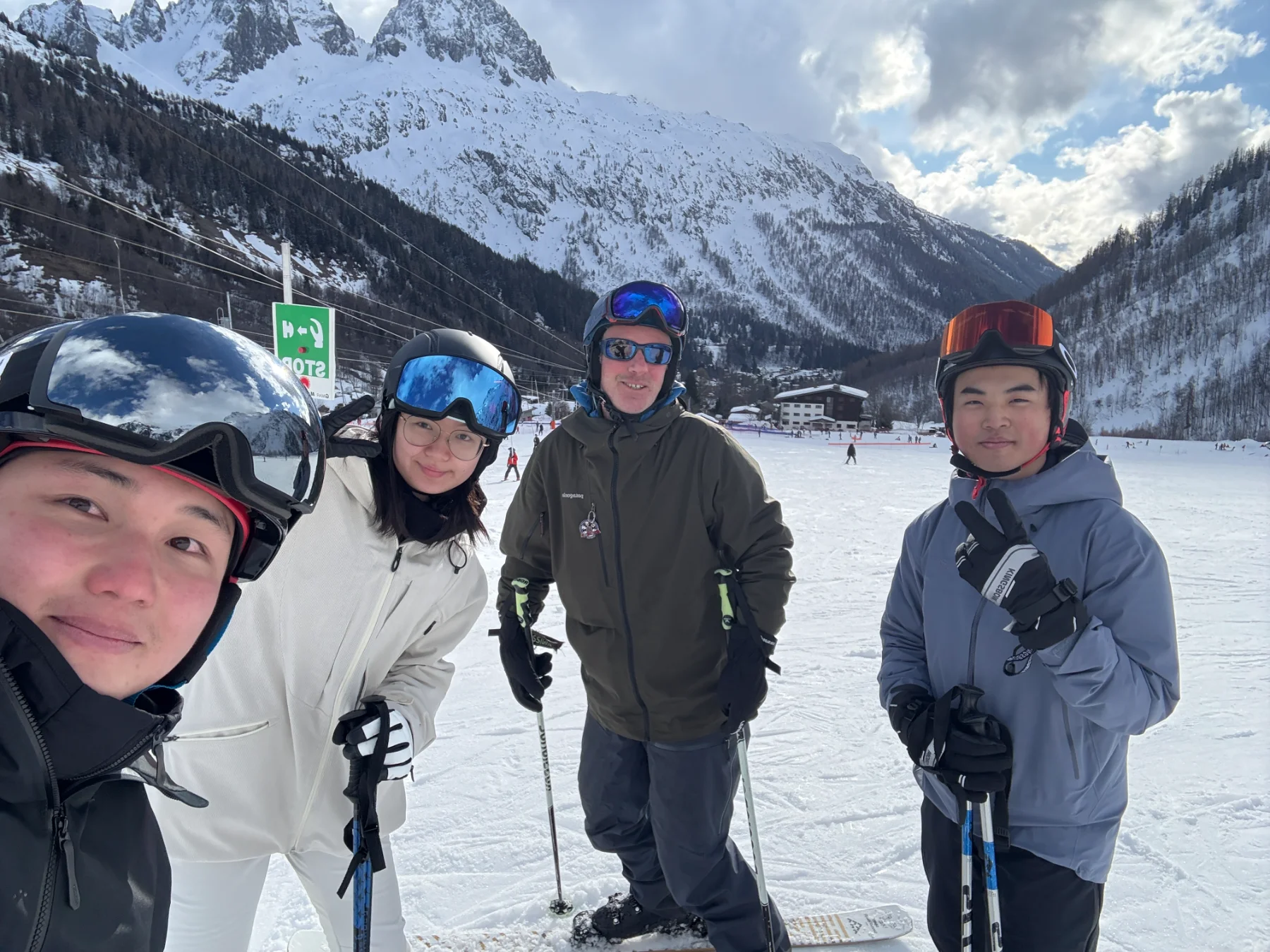 Wilson taking a selfie with three friends on a ski slope in the Alps